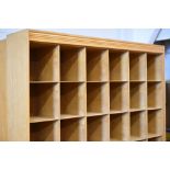 A large lightwood compartmented merchandise unit of thirty six recesses, 205cms high