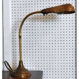 A vintage brass circular based adjustable desk lamp