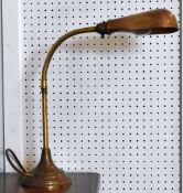 A vintage brass circular based adjustable desk lamp
