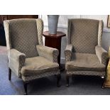 A pair of vintage wing back chairs