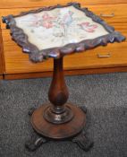 A Victorian rosewood pole screen/table on a circular base with four scroll supports and having a
