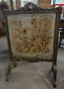 An antique Rococo style firescreen with embroidery panel and acanthus leaf decoration