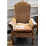 A stripe upholstered vintage armchair on cabriole supports