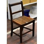 A simple wooden schooling chair with slatted seat