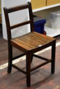 A simple wooden schooling chair with slatted seat