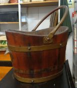 An interesting banded oak (with bucket handle) and with concave lip and bearing brass plaque