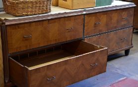 A four drawer department store cabinet composed of two pairs of side by side drawers with metallic