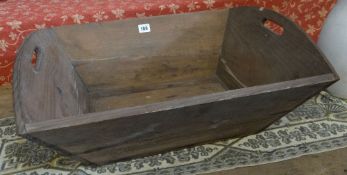 A primitive wooden twin handled log bin