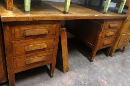 A larger vintage oak kneehole office desk with two flanks of three drawers