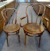 A bentwood elbow chair and matching smaller chair both with poker work circular seats