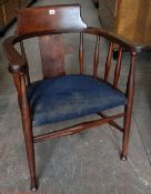 A vintage captain style elbow chair with padded and upholstered seat