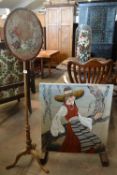 A tripod pole screen with oval tapestry panel together with a standing fire screen with pictorial