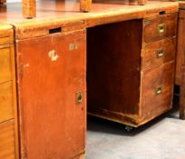A vintage kneehole desk with flank cupboard and three flank drawers