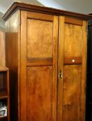 A two door pitch pine chapel closet with metallic handle and internal clothes rails and shelf