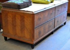 A four drawer department store cabinet composed of two pairs of side by side drawers with metallic