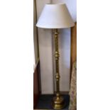 A brass/brassed twist column circular based standard lamp and shade