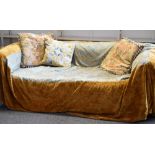 A blue fabric Chesterfield style sofa with excellent floral silk damask throw with a pair of