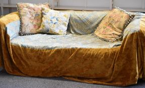 A blue fabric Chesterfield style sofa with excellent floral silk damask throw with a pair of