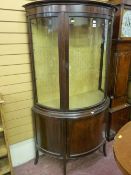 A late Victorian mahogany demi-lune display cabinet with cupboard base on splayed feet (one side