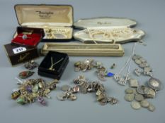 A parcel of mixed jewellery including silver charm bracelets, a yellow metal bar brooch with