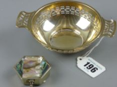 A small circular pierced bowl with twin handles, 1.4 troy ozs, Birmingham 1945 and a white metal and
