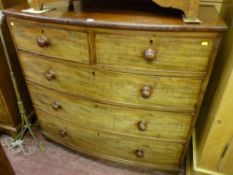 A Victorian mahogany bow front chest of two short over three long drawers with turned wooden knobs