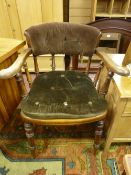 A late 19th Century smoker's bow armchair, cane seated with additional button upholstered pad and