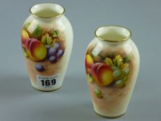 Royal Worcester 'Fallen Fruit' vases - two hand painted vases with gilt rims, signed 'Roberts',