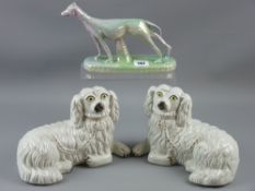 A rare pair of recumbent Staffordshire spaniels, circa 1900 with gilt decorated collar and chain (