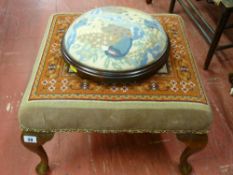 A circular Victorian tapestry top footstool on ball supports and a polished tapestry top square
