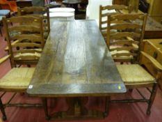 An antique rustic oak refectory style dining table with peg jointed block stretcher, 74 x 184 cms,