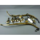 A pair of antique polished brass horse hames with iron fittings with a quantity of horse brasses