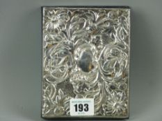 A floral embossed hallmarked silver and leather bound address book, unused and dated London 1989