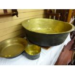 A very large antique brass bowl, 29 cms deep x 87 cms diameter, a 43 cms diameter brass bowl and