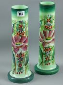 A pair of Victorian milk glass vases with hand painted floral decoration on green glass in