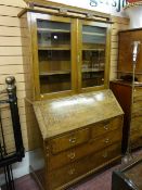 A late 19th Century two piece oak bureau bookcase chest, the upper section having two doors with