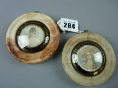 Early 20th Century portrait miniatures, a pair, probably on ivory slips of ladies, indistinct