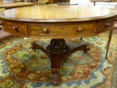 A William IV mahogany circular topped drum type dining table with substantial turned centre pedestal