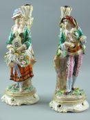 A pair of Continental porcelain figural stands showing a well dressed young man playing a lute and a