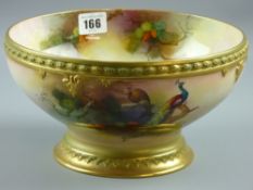A large Royal Worcester footed bowl, hand painted by Albert J Schuck of peacocks upon pine tree