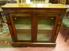 A Victorian inlaid walnut two door side cabinet with brass embellishments, velvet lined interior