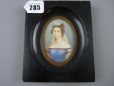 A miniature half length portrait of a young woman in classical dress, watercolour on ivory slip in