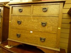 A late Victorian oak chest of two short over two long drawers with copperized ring pull handles on