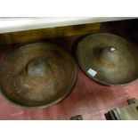 A pair of circular cast iron feeding troughs with raised dome centres, 68 cms diameters