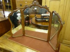 A French style carved mahogany triple dressing table mirror with bevelled edge glass, 54 x 110 cms