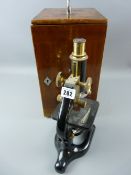 A mahogany encased brass and black metal microscope by Prior & Co with four supplementary lenses and