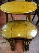 A set of three walnut tray top side tables, the largest being kidney shaped, 55 x 55 cms and a