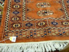 A red ground Eastern woollen prayer mat with tasselled edge, 84 x 64 cms approximately