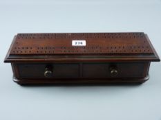 A Victorian rosewood cribbage board with two lower drawers on bun feet, 9.5 x 34 cms