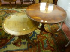 A reproduction yew circular topped tripod table with centre ebony and light wood inlay and a